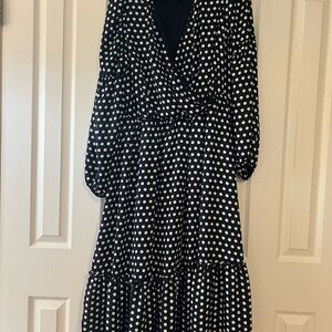 Fun, flirty, black dress with white polkadots sized one X.